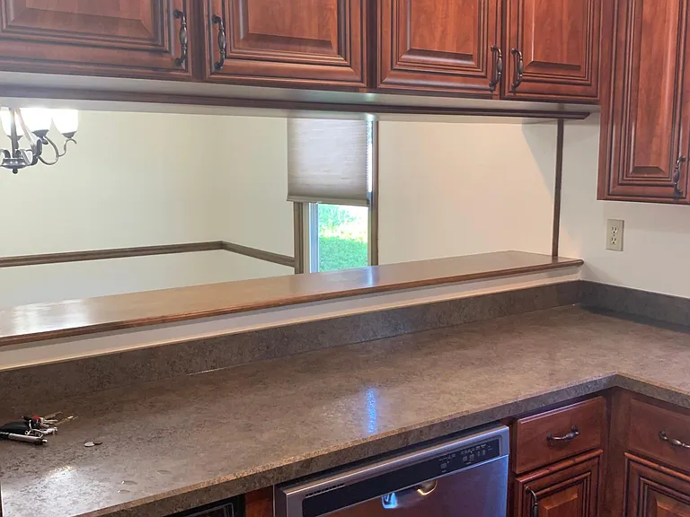 Kitchen with pass through to dining room.