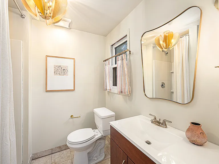 A simple yet elegant bathroom with all essentials, designed for convenience and a calm, refreshing experience.