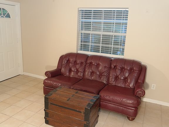 The living room is large enough for a full sofa. The window