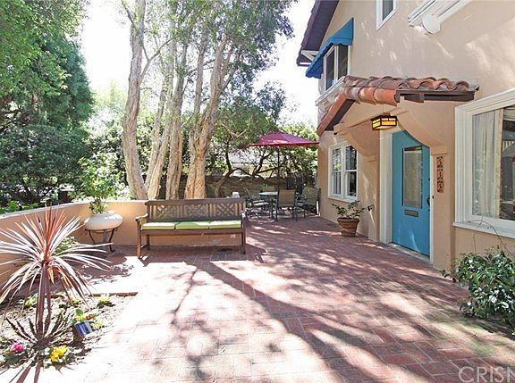Amazing oversize brick front porch, offering inspiring views of lush surroundings, regal oak tree, u