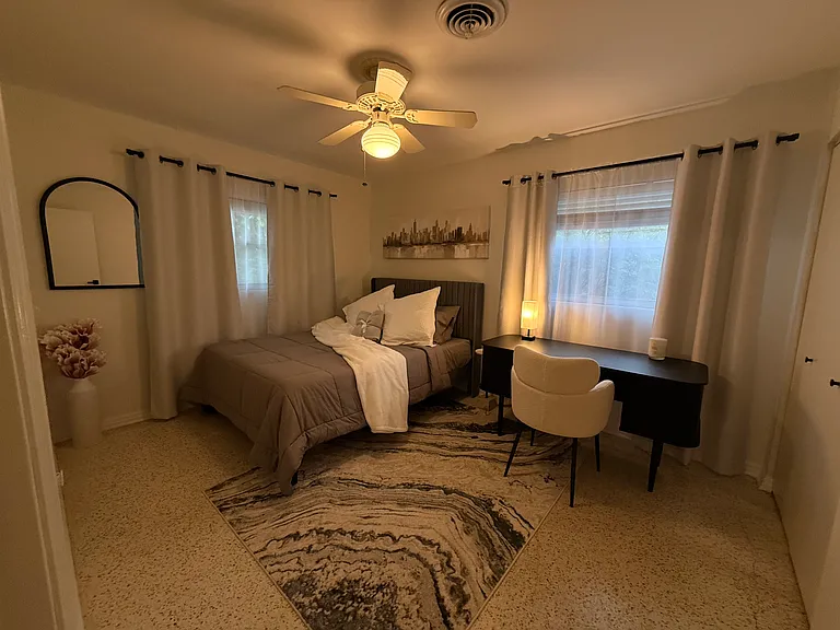Second bedroom with closet and large desk.
