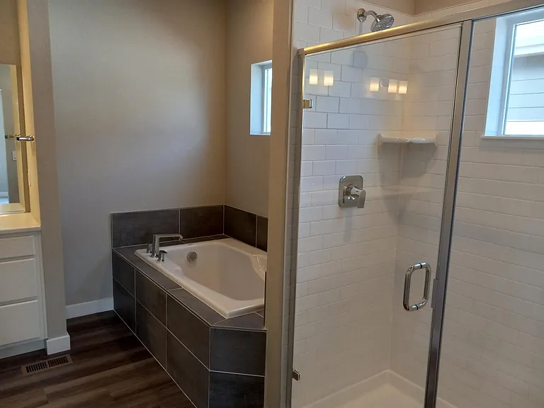Master Bathroom has both a walk-in shower (with seat) and a premium bathtub. Each with it's own window.