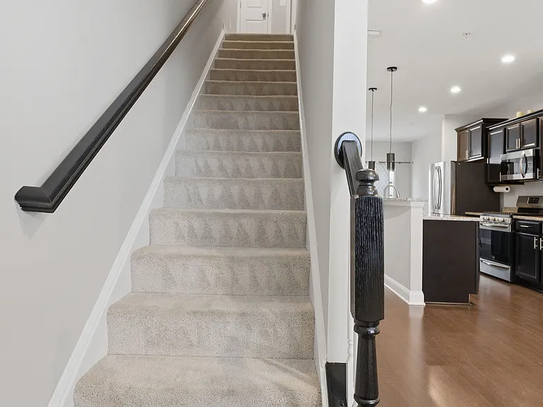 2nd-floor staircase leading to the 3rd floor with 2 bedrooms.
