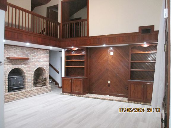 View from dinette/kitchen- vaulted 20 ft ceiling--Wide open floorplan with wood burning fireplace