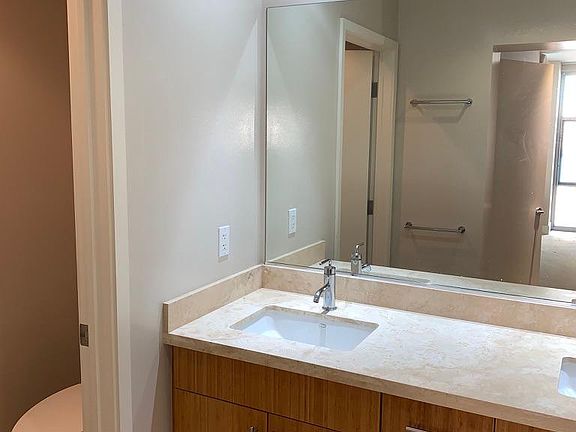 Master bedroom en suite bathroom with double vanity and commode