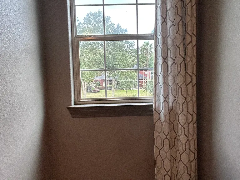 upstairs bedroom view of beautiful home across the street
