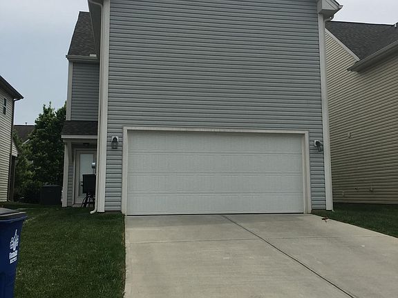Back of home- back patio to left and 2 car garage 