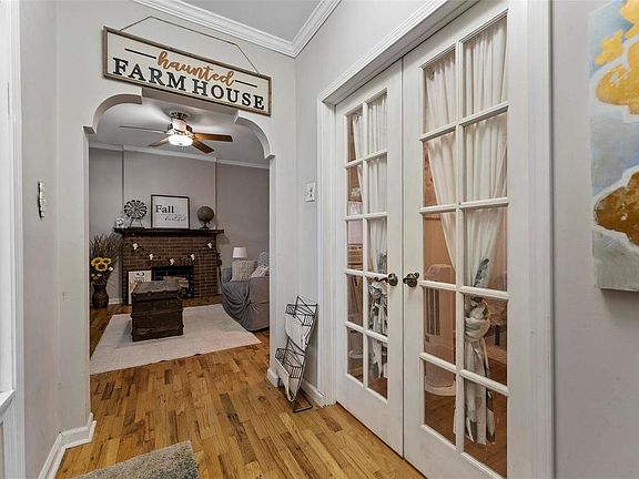 Inside the front door looking towards the living room is the front bedroom with beautiful French entry doors