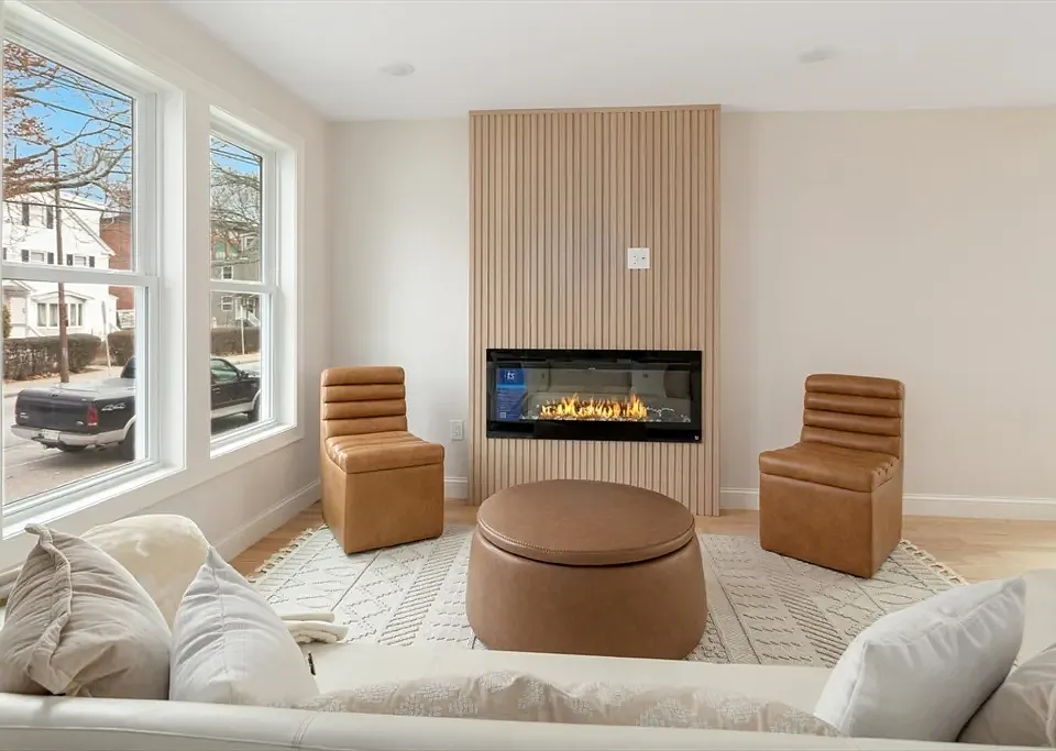 Sun-drenched living area with oversized windows and high-end modern finishes.