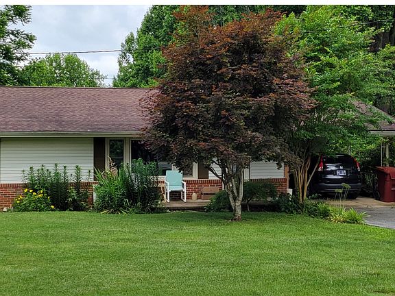 Upper level unit. Driveway and carport
