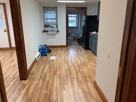 View into kitchen from living room. Bedroom with private backyard access through the door on the left, bathroom is straight ahead.
