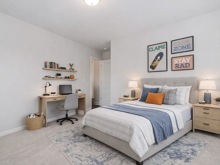 Guest bedroom featuring a queen bed with a dedicated desk and chair workspace.
