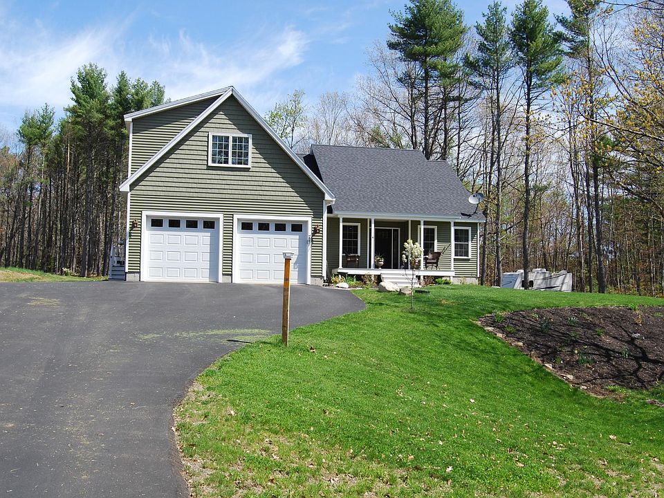 Front view, apartment is above the garage with entrance on left.