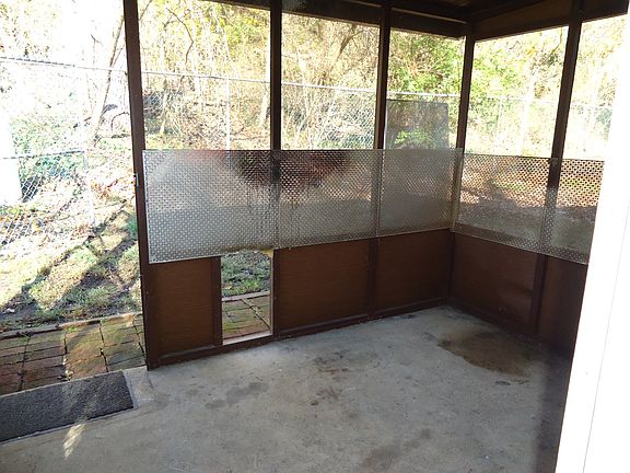 Enclosed back porch with doggie door.