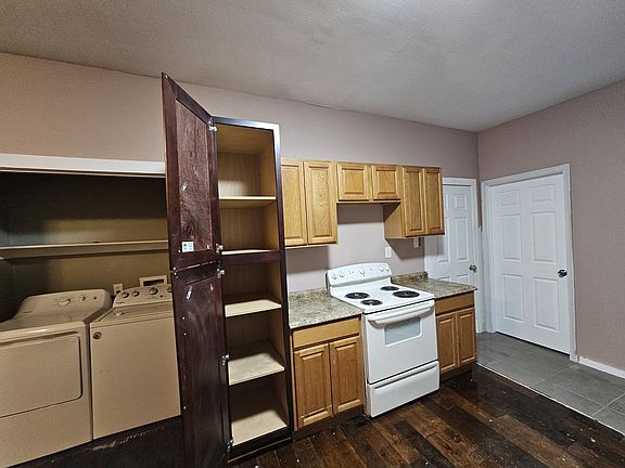 Left side of the kitchen with indoor laundry closet