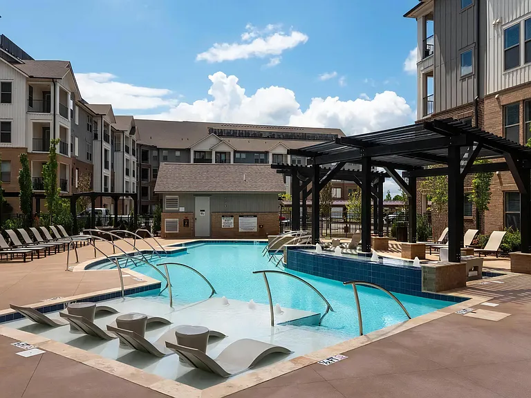 Sleek Poolside Escape with Umbrella Loungers and Water Jets