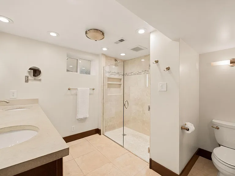 Basement level full bathroom, double sinks, walk in shower
