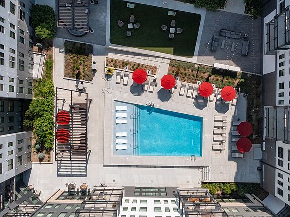 Dive into elevated living with stunning city views from the rooftop pool.