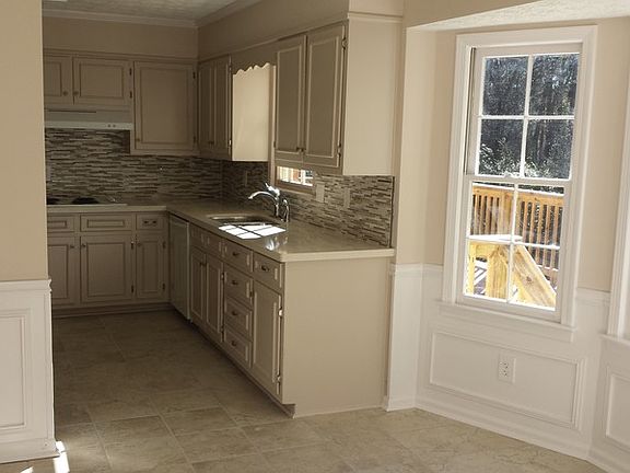 Spacious breakfast area w/bay windows
						:
						Spacious breakfast area with large bay windows overlooking private, wooded yard