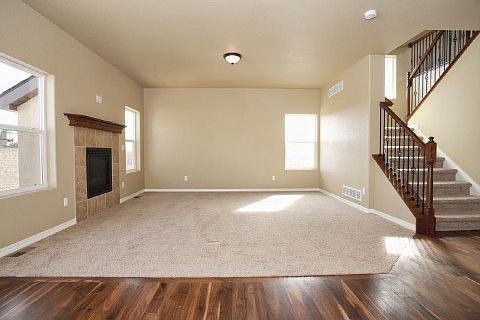 Great room has fireplace with tile surround