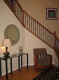 Expansive entry with soaring ceilings and sweeping stairway.