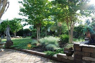 TINY PORTION OF PATIO AND BACK YARD