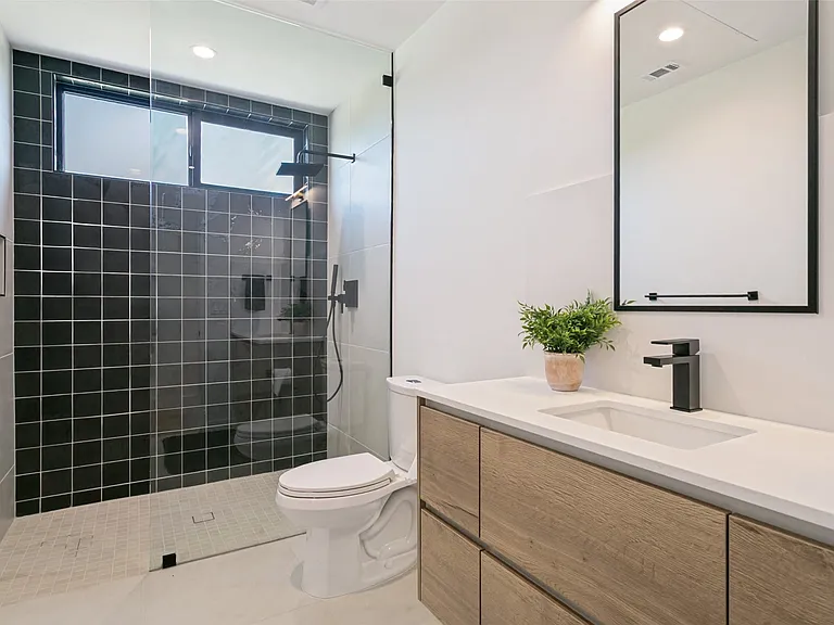 Full bathroom separating bedrooms 1 & 2. Located on 1st floor.