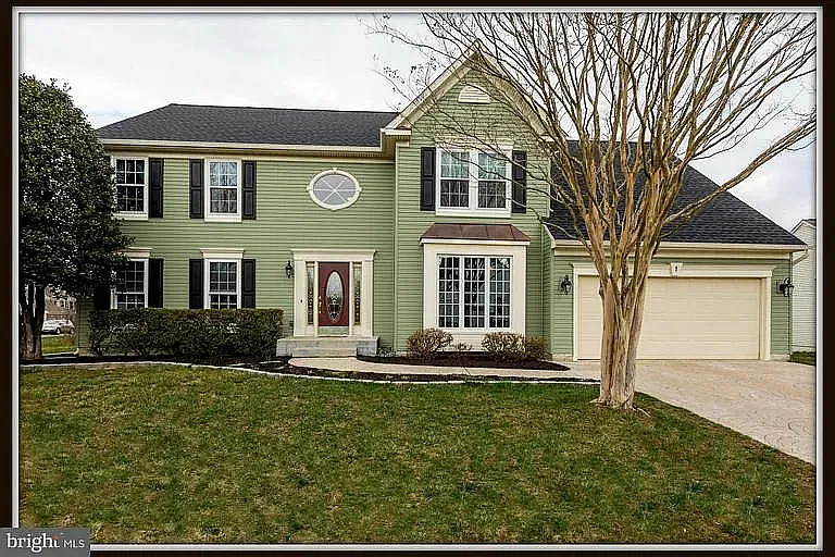 View of the front of the house, has been landscaped since this photo was taken, and front door has been replaced.