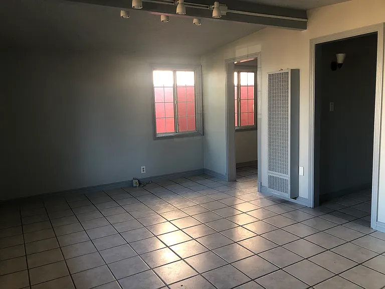 Living Room/Dining room. Left door to kitchen, Right door hallway to rooms and bathroom