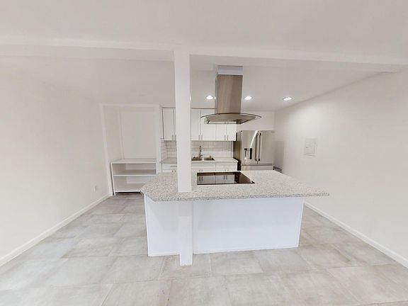 Kitchen with new countertop, and induction stove. refrigerator is included.

Owner installed new in unit clothes washer and dryer and countertop dishwasher to the left of the sink after pictures were taken.