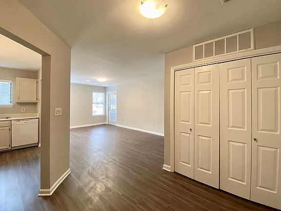 Open floor plan view from front door. Washer dryer in closet with bifold doors. Kitchen to the left.