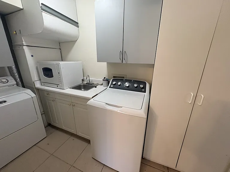 Laundry room with washer, dryer, portable dishwasher.
