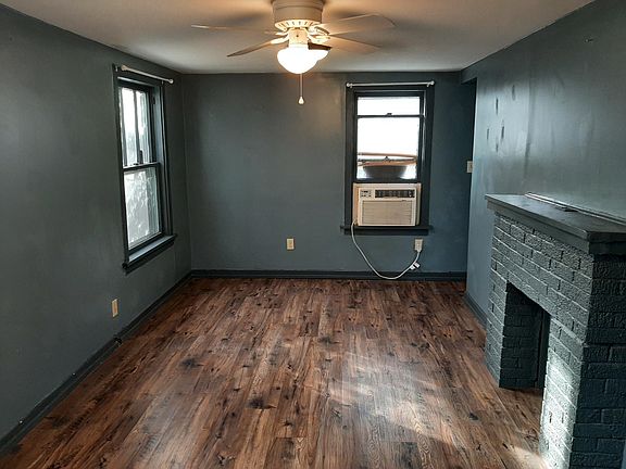 Studio - view from inside front door; small closet is to right, out of view. Kitchen and bath are behind the fireplace wall. Fireplace is decorative. Flooring is LVP