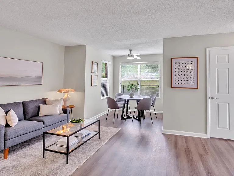Experience the graceful transition from living room to dining area, complete with an inviting ceiling fan. A symphony of grace and space unfolds.