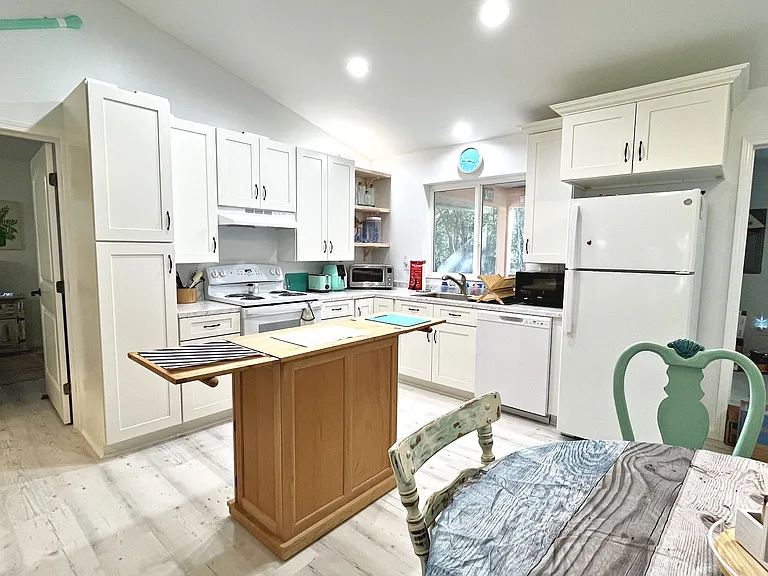The bright kitchen makes for pleasant culinary preparation. The open plan means no one is stuck in the kitchen away from the rest of the family or friends.
