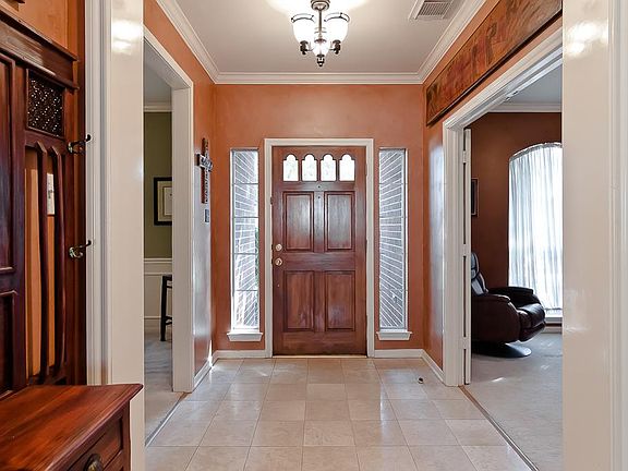 Spacious entry with crown molding and tile floor lead you into the heart of the home.