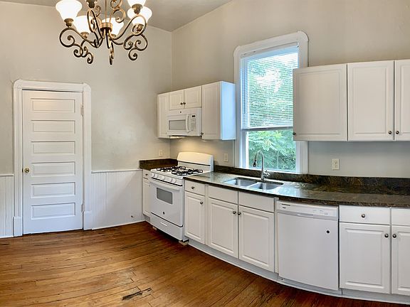 Custom cabinets with granite countertops. Includes GAS stove, microwave, dishwasher, fridge.