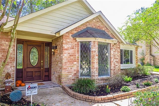 Beautiful, heavy front door with leaded glass matches the front bay window.