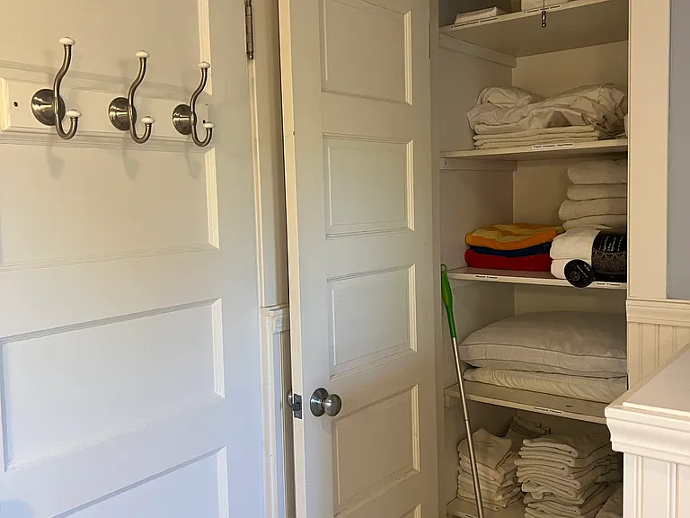Behind Bathroom Door is LInen Closet with labels on each sheet and towel type for easy access.