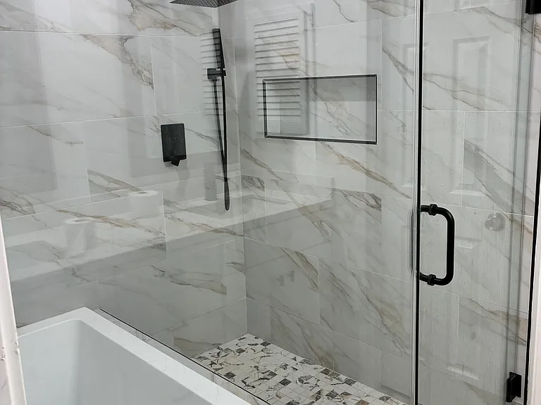 Newly renovated master bathroom with tub and walk in shower