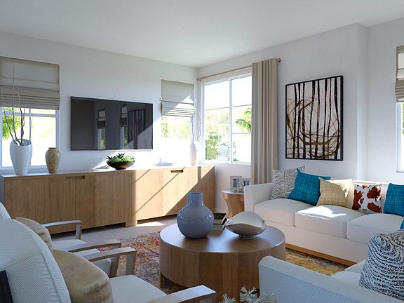 Spacious great room with island kitchen, dining areas as well as a covered deck