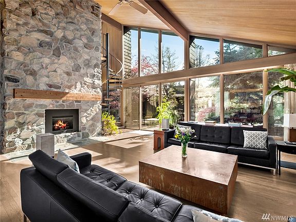 Great Room features Vaulted Tongue and Groove Hemlock Ceiling, Masonry Stone Gas Fireplace, LARGE Windows for an Abundance of Natural Sunlight. 
