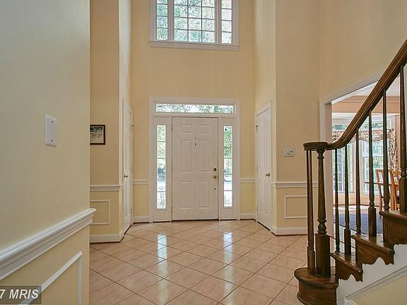 Sunny two story foyer with upgraded trim work