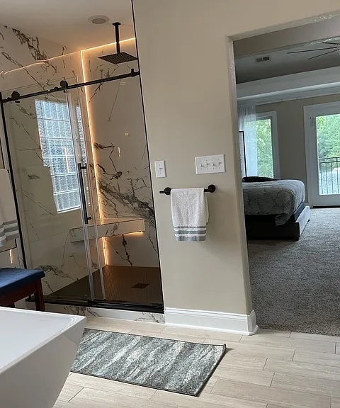 View of bedroom from primary bathroom