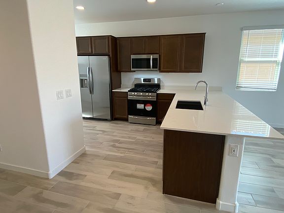 Modern kitchen equipped with all-new stainless steel appliances for a sleek, contemporary look.