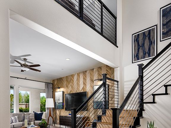 The entryway leads to the Great Room with soaring high ceilings a glimpse of the Loft at the secon