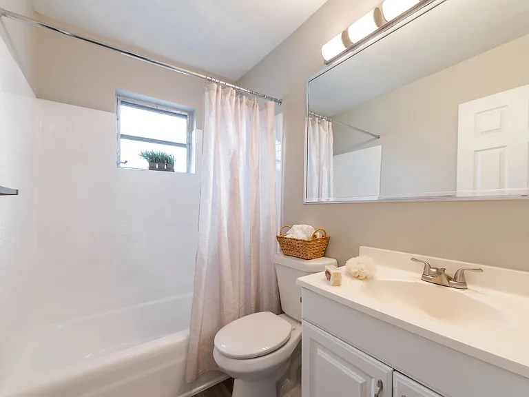 Indulge in bathroom perfection with modern countertops and an expansive mirror.