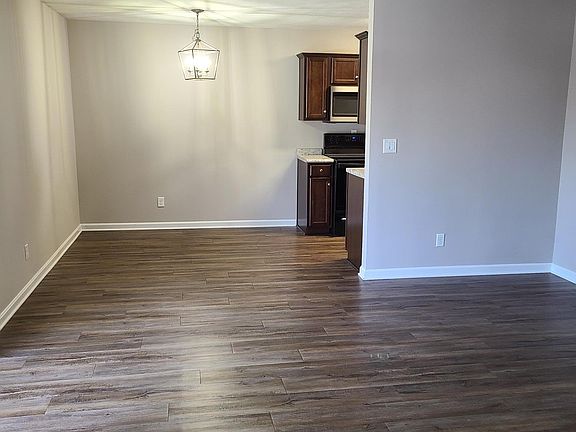 Walking into the apartment, large living room open to the dining area.