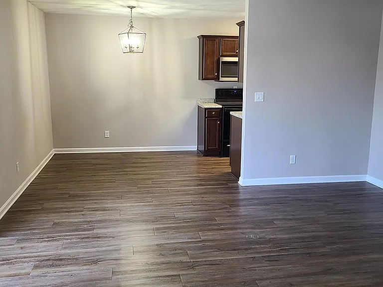Walking into the apartment, large living room open to the dining area.