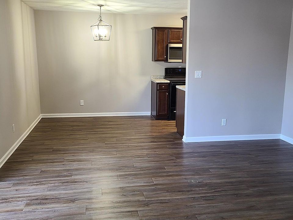 Walking into the apartment, large living room open to the dining area.